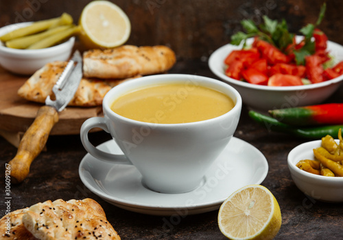 lentil soup served in cup with lemon