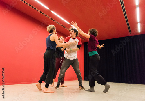 Obraz na plátně Group of young students standing and quarreling in dance class.