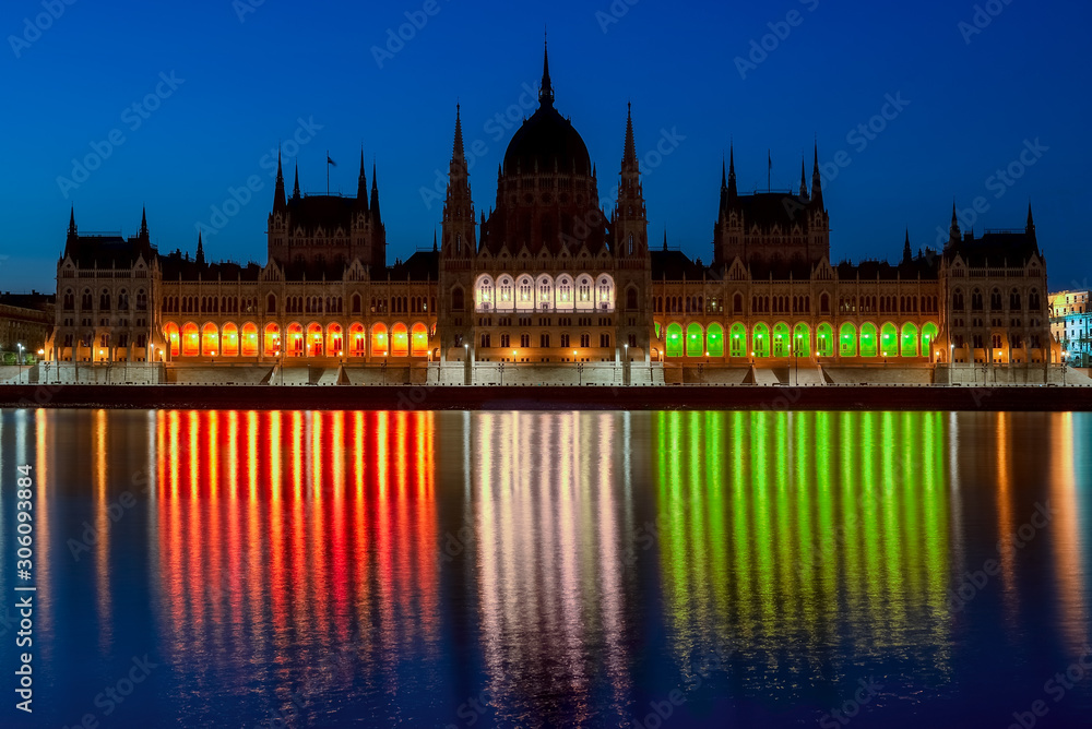 The Hungarian parliament luminous with the national colors.