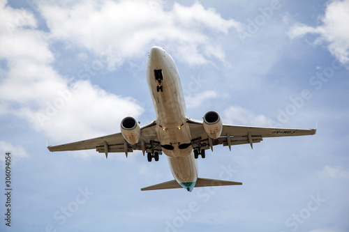 Close up of passenger plane landing overhead