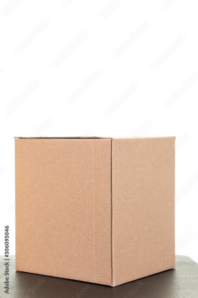 One cardboard box brown in white background black table One cardboard box brown in white background black table