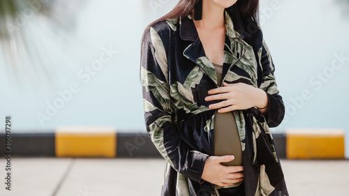 Elegant style of a pregnant woman in a modern city. Fashion trends for pregnant women