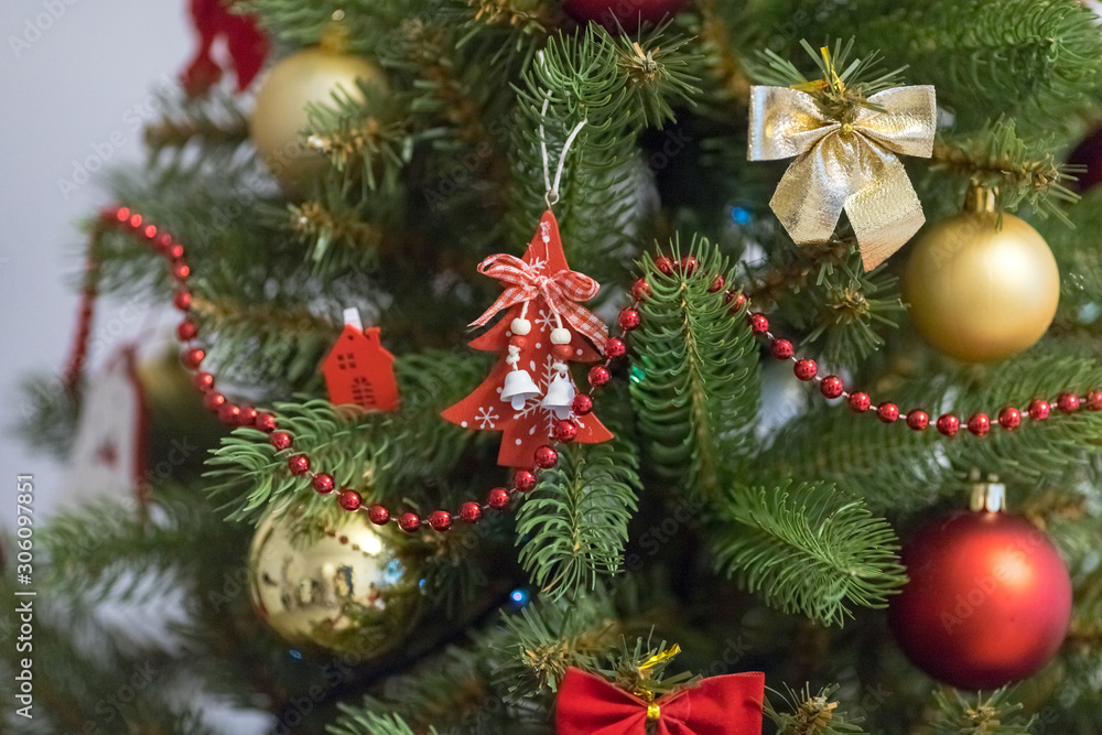 Fototapeta premium Christmas decoration and celebration. Christmas tree. Xmas red and gold balls. New Year preparations. New Year concept. Christmas tree toys.