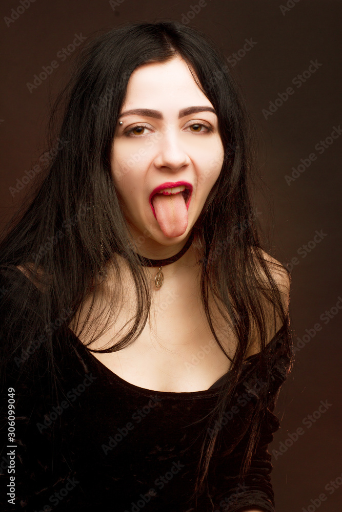 brunette on dark background dressed in goth style brunette on dark background dressed in goth style