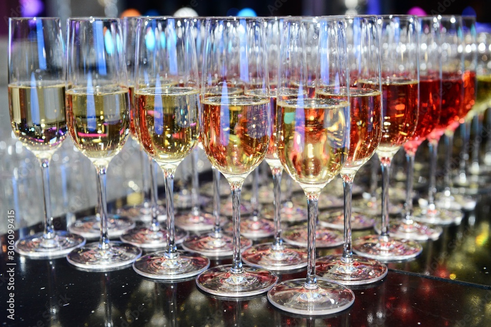 Rows of full champagne, sparkling wine and red wine glasses. Dining, drink. Catering service concept. Rows of full champagne, sparkling wine and red wine glasses. Dining, drink. Catering service concept.