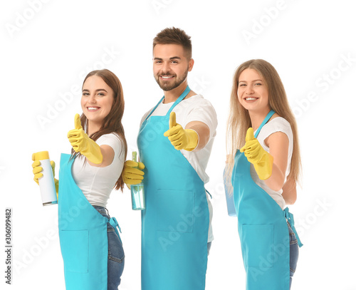 Team of janitors showing thumb-up gesture on white background