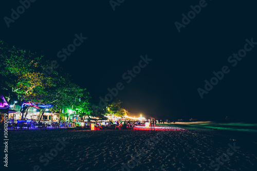 Many shops during the night time by the beach