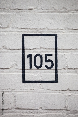 number 105 on white wall