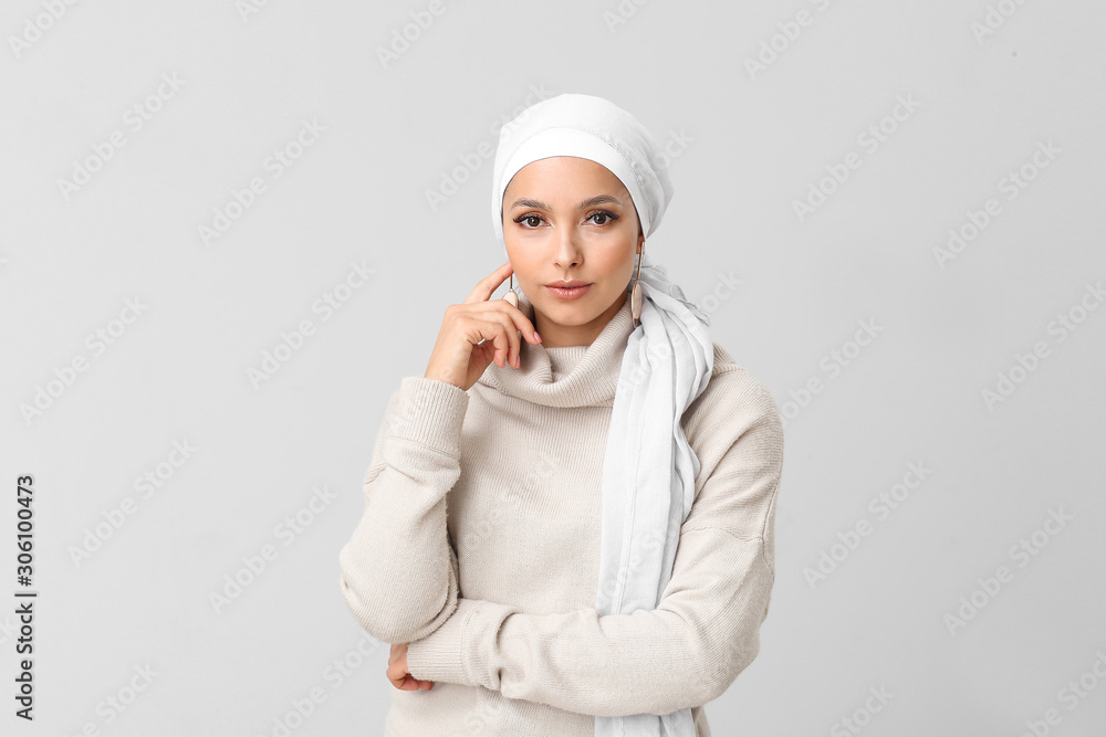 Portrait of beautiful Muslim woman on light background Portrait of beautiful Muslim woman on light background
