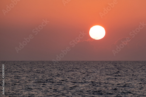Fototapeta Naklejka Na Ścianę i Meble -  Sunset over the sea. Orange color of the sky