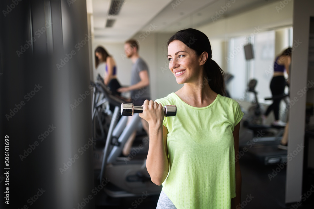 Portrait of fit sporty woman holding weights Portrait of fit sporty woman holding weights