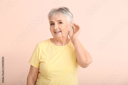 Senior woman with hearing a...
