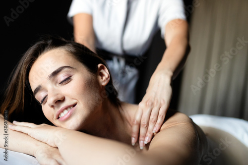 Young beautiful woman in spa environment during massage treatment