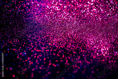 Pink/blue shiny glitter on black background. Macro shot, shalow DOF. photo