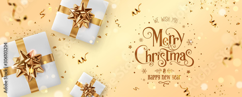 Gold Christmas and New Year Text on gold Xmas background with gift boxes, fir branches, gold ribbon, decoration, sparkles, confetti, bokeh. Merry Christmas card. Vector Illustration, realistic vector