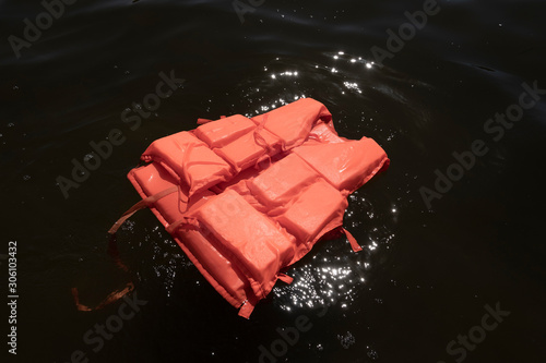 Photography Orange life jacket in sea water.