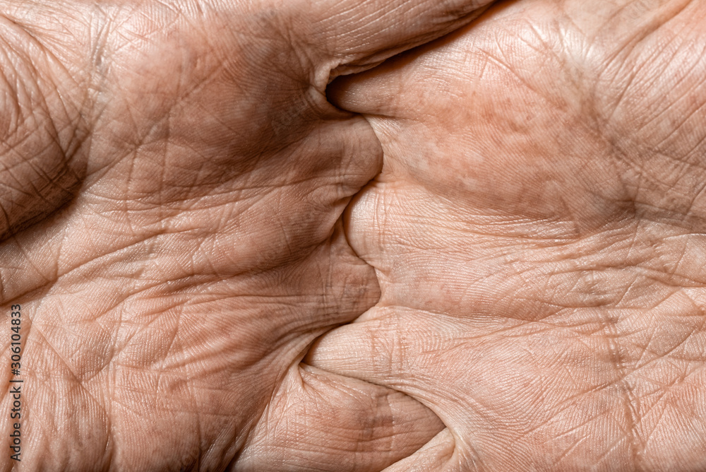 Fototapeta premium Color photo of senior man hands with crossed fingers