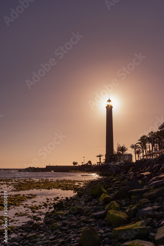 The lighthouse at the shore of the Atlantic Ocean in Maspalomas on the isle of Gran Canaria