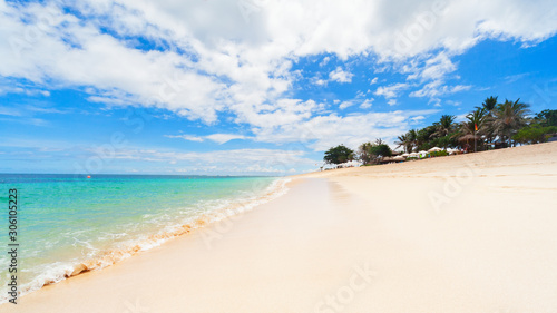 Scenic view of tropical beach with clear turquoise water and white sand. Niko beach is popular place for day tours. Nature of Bali island, best travel destinations on family vacation in Indonesia. photo