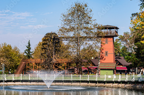 Water mill in the city square and water pool in the foreground, Sakarya, Turkey