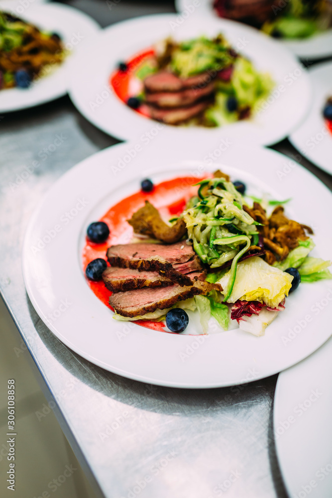 Cooking a delicious main course in the restaurant kitchen. Catering on holiday. Cooking a delicious main course in the restaurant kitchen. Catering on holiday.