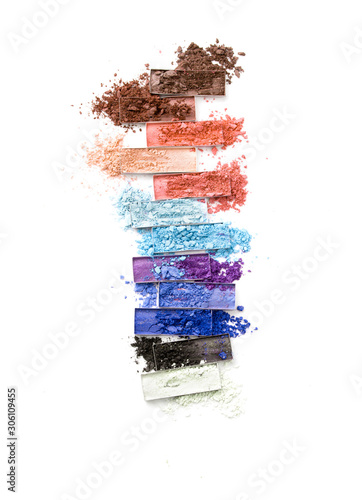 Fototapet Multicolored crushed eyeshadows with brush isolated on white background