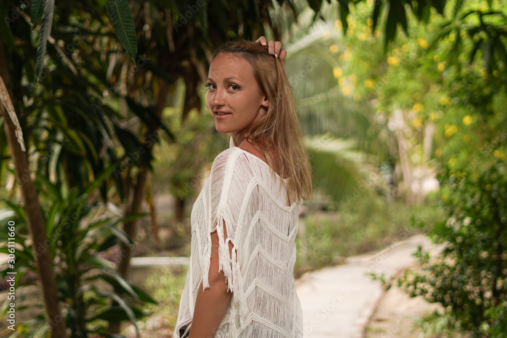 The girl in a white dress in the garden. The girl in a white dress in the garden.