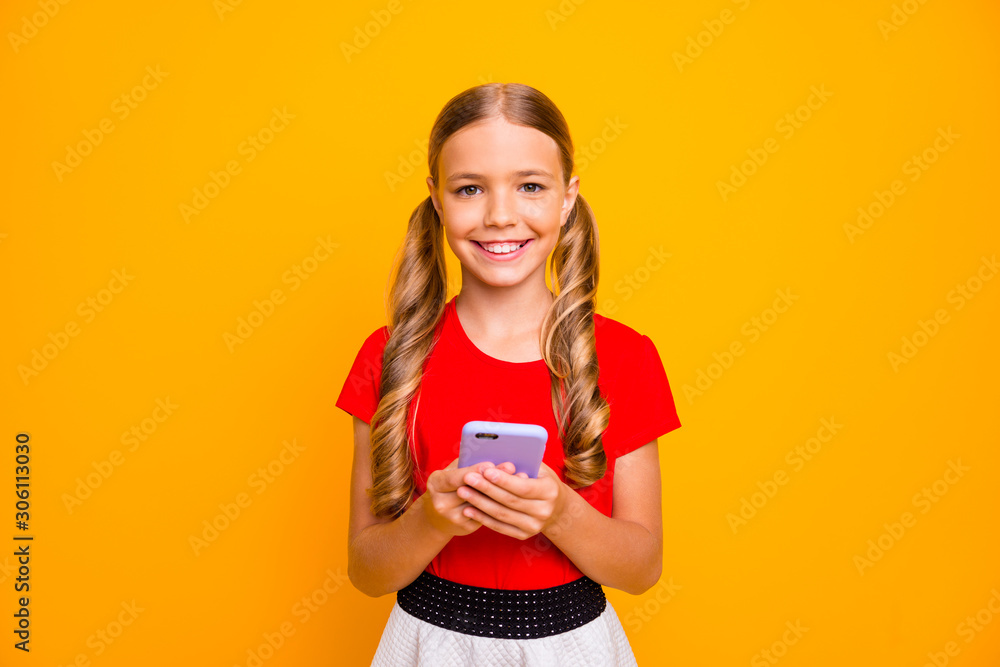 Photo of pretty small lady holding telephone hands young influencer writing new post for own popular blog wear casual red white dress isolated bright yellow color background Photo of pretty small lady holding telephone hands young influencer writing new post for own popular blog wear casual red white dress isolated bright yellow color background