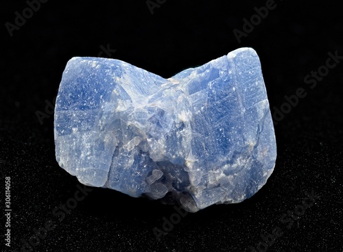 Light blue calcite mineral rough stone isolated on black background