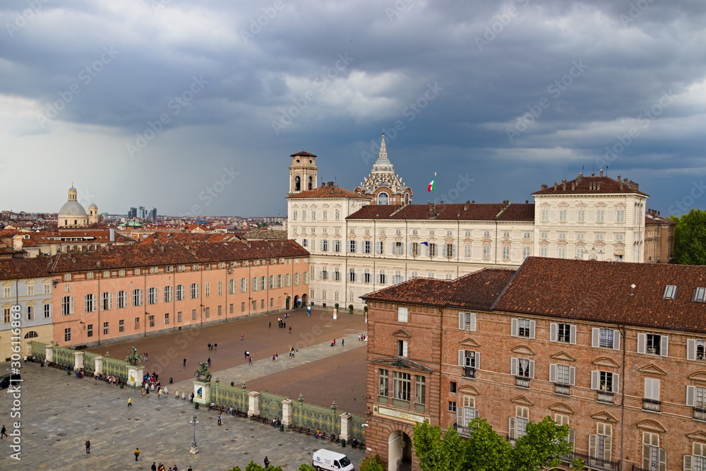 Turin, Piedmont, Italy - May 05, 2019: Aerial view from Palazzo Madama tower on Castle Square and Royal Palace with the Cathedral Dome against a cloudy overcast sky