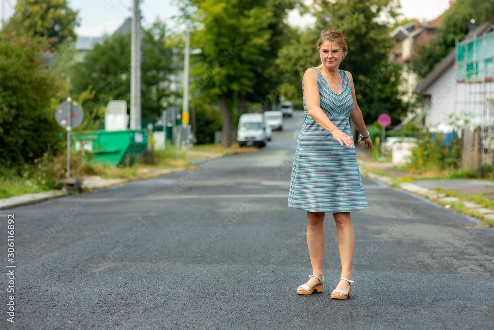 Woman with rotating poses on the road