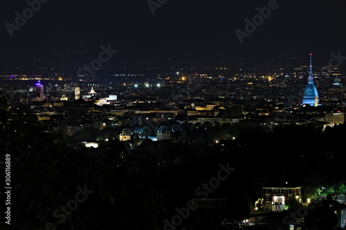 Torino, Italy - October 29, 2019: Panoramic aerial night view on Turin city center with Mole Antonelliana lighted in blue, from Europa Park in Cavoretto