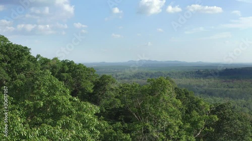 Revealing shot of the mass amount of green forestry in Peramun Hill on Belitung Island, Indonesia photo