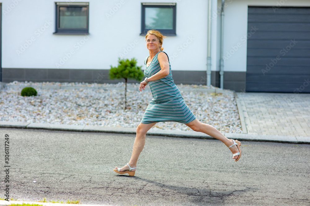 Woman is running and jumping in the street