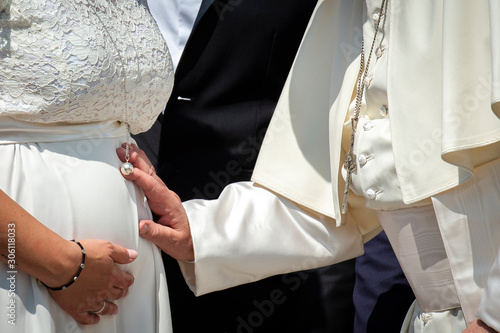 Vatican City - June05 , 2019: Pope Francis blesses the belly of a pregnant woman at the end of his weekly general audience in St. Peter's Square at the Vatican. photo