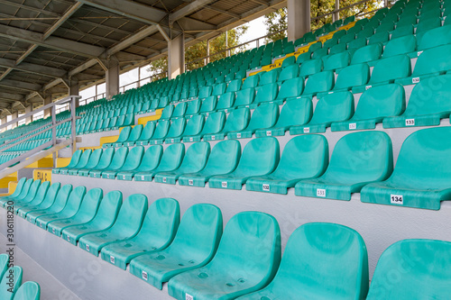 Racing stadium bleachers with green seats