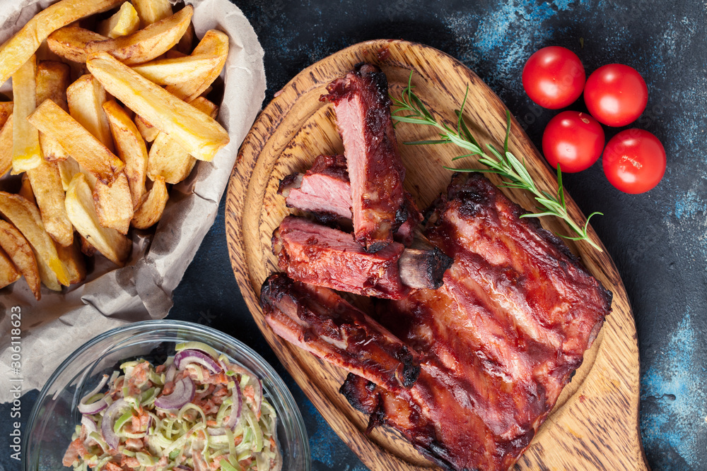 Spicy barbecued pork ribs served with BBQ sauce Spicy barbecued pork ribs served with BBQ sauce