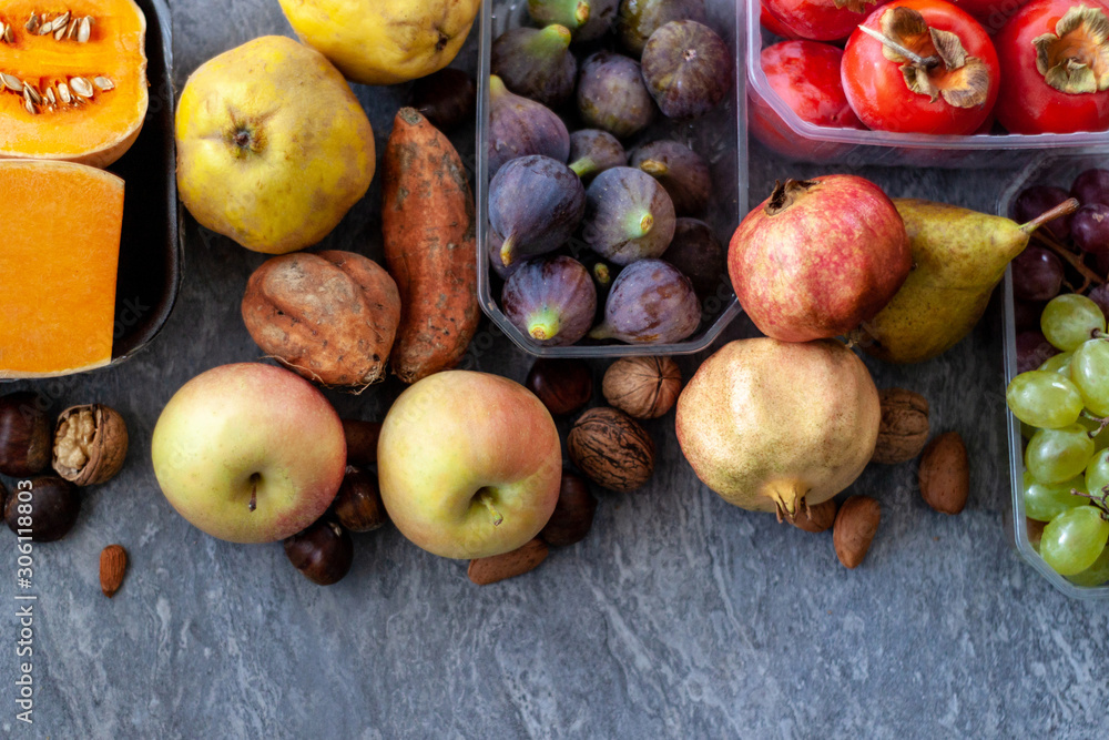 .Top view to fall fruits over a grey  background with copy space.