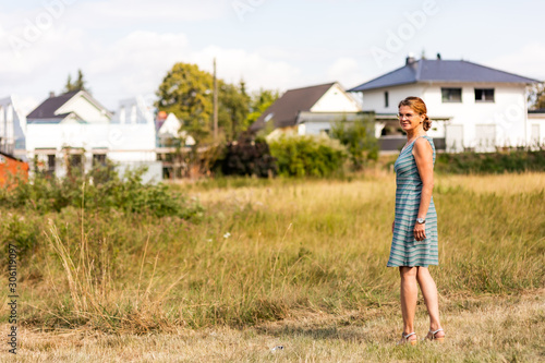 Woman on the meadow in the construction area