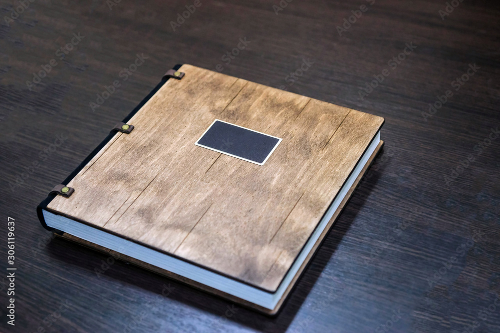 Photo blank. Open square format brochure on a wooden table Photo blank. Open square format brochure on a wooden table
