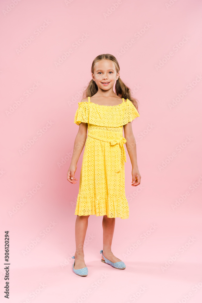 smiling and cute kid looking at camera on pink background smiling and cute kid looking at camera on pink background