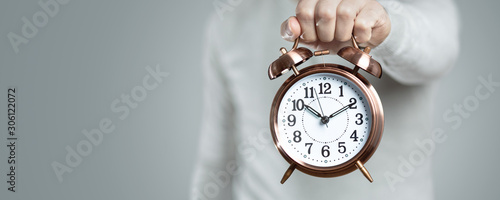 Retro clock held by the hand of a man