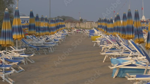 BIBION, ITALY - AUGUST 21, 2019: beach with umbrellas and sunbeds