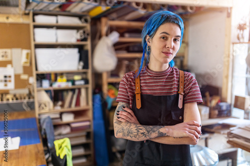 Photos Confident young craftswoman in her workshop