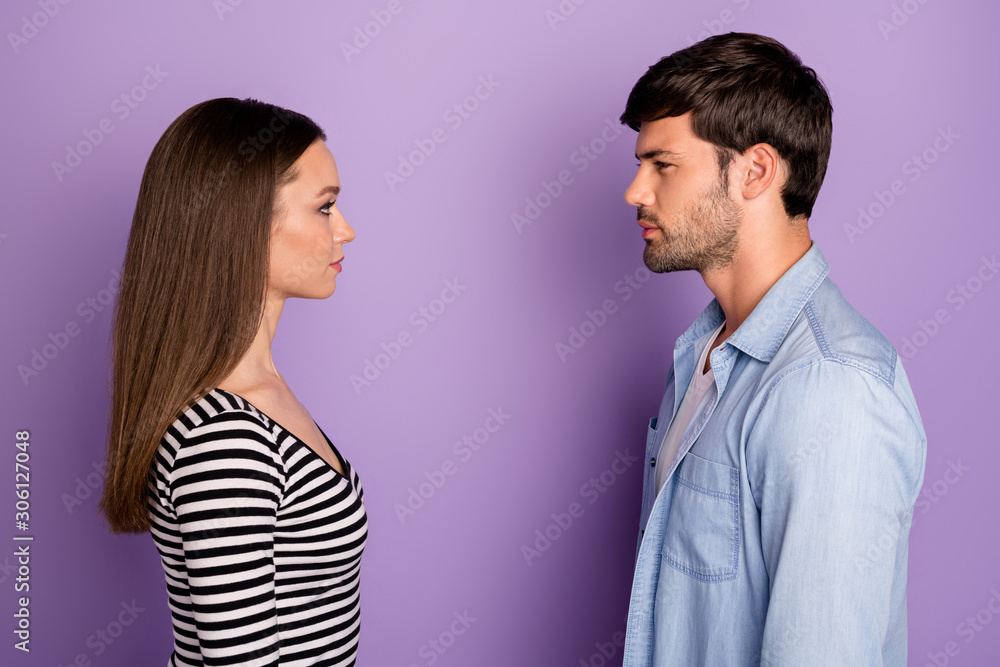 Profile photo of two people couple guy lady standing opposite looking eyes have conflict situation wear stylish casual outfit isolated pastel purple color background Profile photo of two people couple guy lady standing opposite looking eyes have conflict situation wear stylish casual outfit isolated pastel purple color background