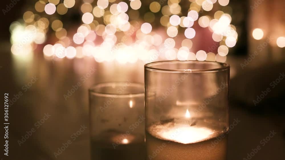 Glass of champagne and burning candles, closeup. Bokeh effect Glass of champagne and burning candles, closeup. Bokeh effect