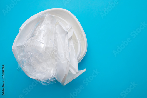 plastic dish and plastic cup on  blue paper background