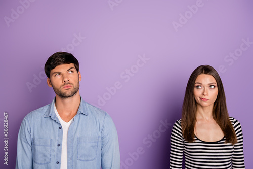Photo of two people couple looking distrustful up empty space have doubts about new product quality wear stylish casual outfit isolated pastel purple color background