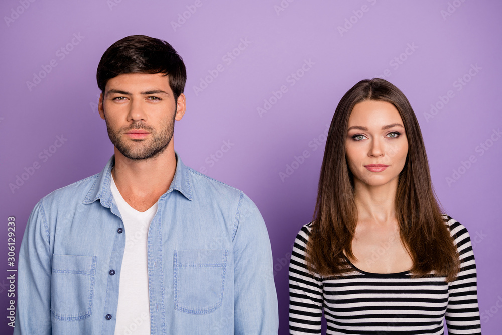 Photo of two funny people couple not smiling looking seriously on camera  not talk to each other wear stylish casual outfit isolated pastel purple  color background Stock Photo | Adobe Stock