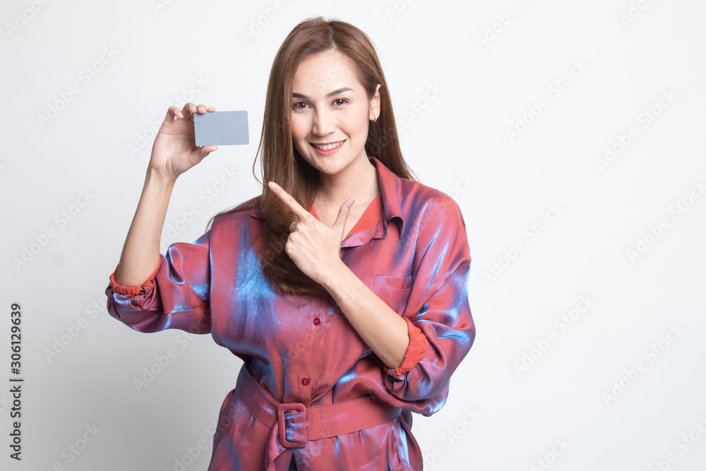 Young Asian woman point to a blank card. Young Asian woman point to a blank card.
